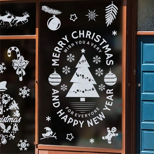 Autocollants de Noël blancs avec Père Noël et rennes sur une porte vitrée