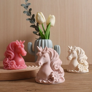 Handmade unicorn candle molds with floral details in rose, pink and white cream colors