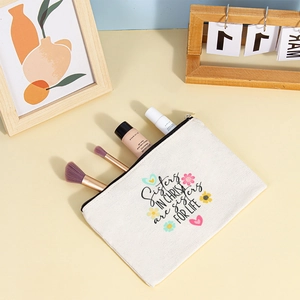 Close-up of canvas makeup bag with Sisters In Christ print showing brushes and skincare items