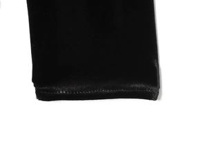Detailed close-up of the professional hem stitching on black velvet dress fabric