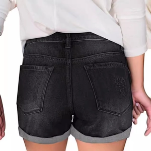 Women's slim fit black denim shorts with ripped details and cuffed hems back view