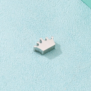 Polished silver stainless steel crown pendant accessory on a light blue background