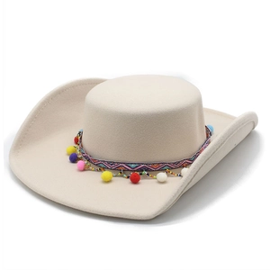 Close-up of beige felt cowboy hat featuring colorful ethnic embroidery and vibrant pom-poms
