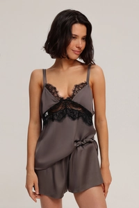 Close-up of silk satin pajamas with delicate lace trim on dark grey camisole and shorts