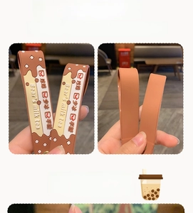 Close-up of PVC milk tea keychain strap with Bear's milk tea text and cute pattern