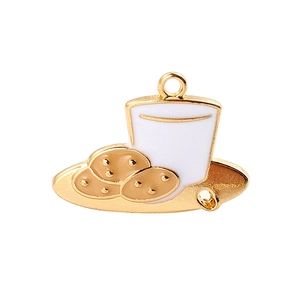 Detail of enamel charm featuring a cookie plate and milk cup with a golden metal finish