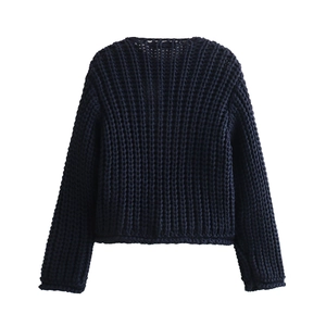 Detail of navy blue chunky ribbed knit cardigan with textured openwork stitch patterns