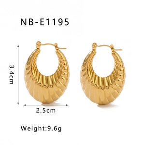 Detailed view of U-shaped gold-plated stainless steel earrings with textured lines