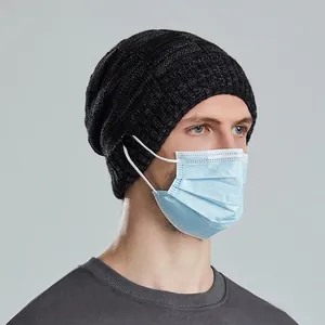 Mens dark grey knit beanie with side buttons for mask attachment and ear pressure relief