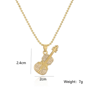 Gold-plated guitar pendant necklace with sparkling crystals and beaded chain on white background