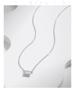 Detail of S925 sterling silver chain with a minimalist rectangle cubic zirconia pendant