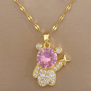 Detailed shot of teddy bear necklace with pink crystal head and sparkling zircon body