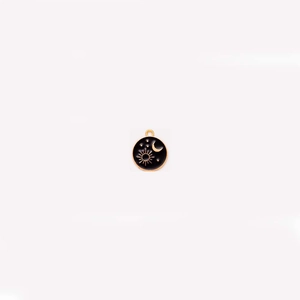 Detailed view of gothic celestial pendant with golden sun, moon and star on black enamel