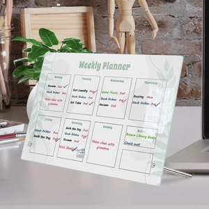 Macro detail of acrylic weekly planner board with metal stand and handwritten notes