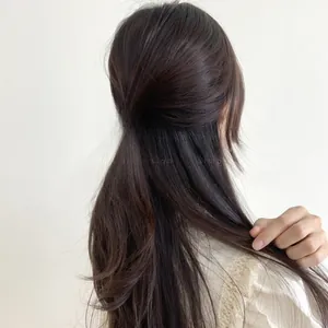 Rear view of a model wearing a pink gradient heart-shaped claw clip for elegant styling