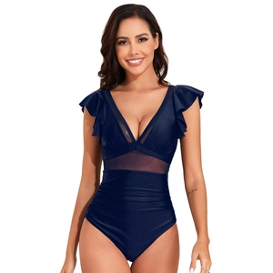 Detail of navy blue one-piece swimsuit featuring mesh panels and ruffled cap sleeves