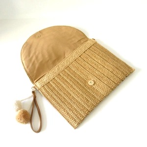 Handwoven straw envelope clutch bag in khaki with decorative pompom and leather strap
