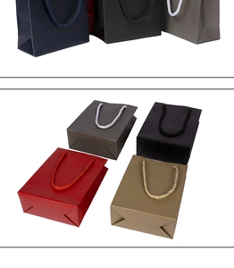 Detail showing woven handles and colorful paper gift bags in red, gold, and blue