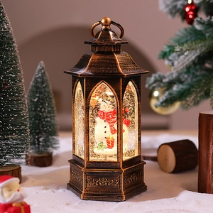 Close-up of vintage bronze Christmas lantern featuring a snowman scene and falling snow