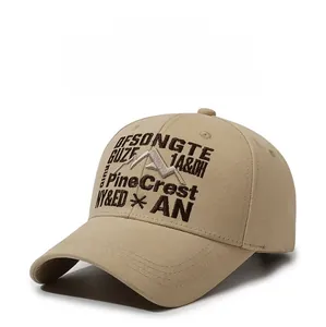 Detail of embroidered mountain peak and PineCrest lettering on vintage khaki baseball cap