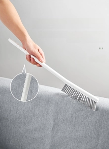 Detail of ergonomic anti-slip long handle and dense gray bristles for deep gap cleaning
