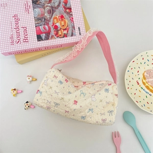 Close-up of quilted canvas bag with bunny patterns and delicate white lace trim
