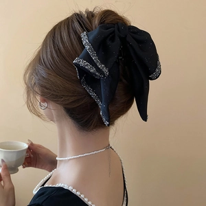 French style large black bow hair claw clip with silver rhinestones on a female model
