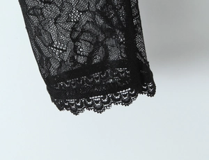Vue macro de la broderie en dentelle noire et des motifs ajourés sur un haut corset