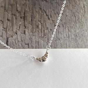 Detailed view of 925 sterling silver croissant pendant necklace with polished mirror finish