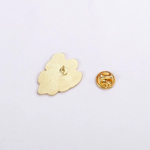 Detailed view of the gold-finish metal badge backing with a secure butterfly clutch pin