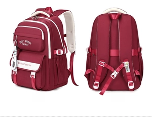 Detail view of burgundy student backpack showing S-shaped straps and side star pendant