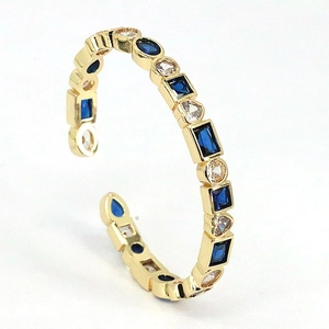 Bohemian adjustable gold ring featuring vibrant blue and clear geometric zircon stones