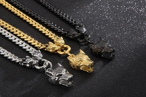 Detailed view of three wolf head necklaces in silver, gold, and black stainless steel