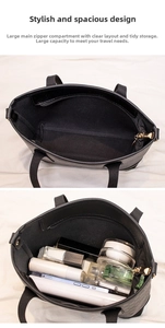 Detail showing high-capacity interior of a black faux leather tote bag with a zipper compartment