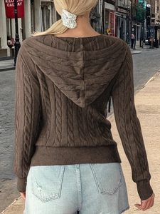 Macro detail of brown chunky cable-knit hooded cardigan from the back view