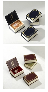 Detail of book-shaped jewelry gift boxes with gold foil stamp and magnetic closure