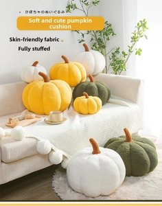 Detail of plush pumpkin pillows in various sizes with soft lamb wool texture on a sofa