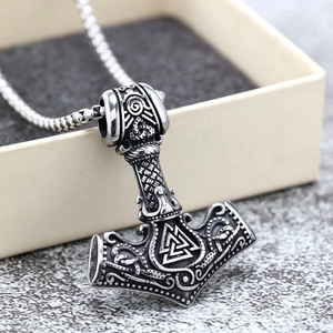 Close-up of a silver stainless steel Viking Mjolnir pendant with Valknut symbol