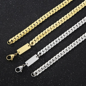 Close-up of gold and silver stainless steel curb chains with blank rectangle tags