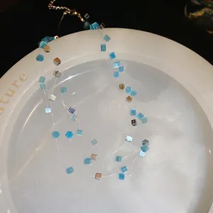 Layered necklace with cube opal stones and silver cubes on transparent wire
