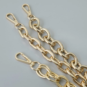 Polished gold metal thick chain strap for handbags with dual lobster clasps detail