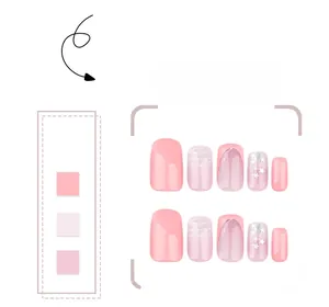 Detail of pink gradient press-on nails with star patterns and French tip design