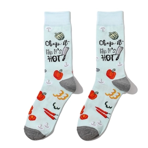 Detail of mint green crew socks featuring 'Chop it like it's HOT' text and veggie patterns