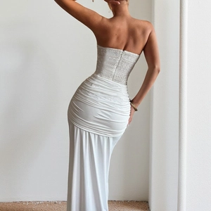 Detail of white evening dress featuring backless strapless design and sequin splicing