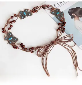 Bohemian braided belt featuring bronze butterfly charms with turquoise blue gemstones