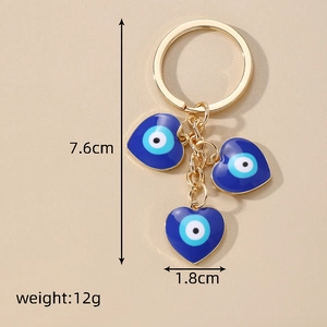 Detail view of blue evil eye heart key chain with dimensions 7.6cm length and 12g weight