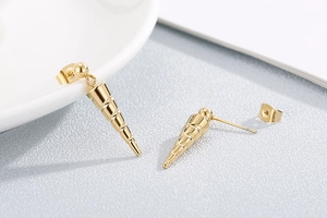 Detailed view of golden conical screw thread earrings with small ball stud accents