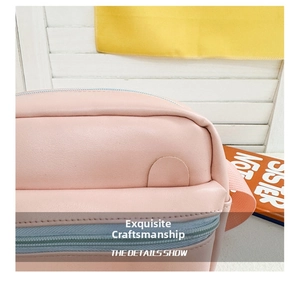 Close-up of pink leather children's bag showing blue zipper and refined stitching detail