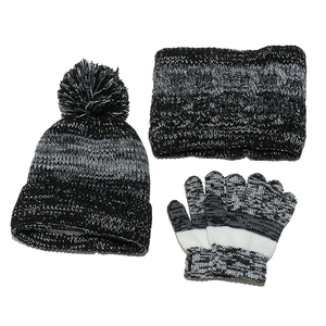 Flat lay of knit winter set with pom-pom hat, scarf and gloves in grey gradient stripes