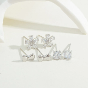 Detailed view of S925 silver stud earrings set featuring floral, bow, and zircon designs